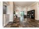 Open living room with tile flooring, columns, and a large bookcase at 6357 Ashley Dr, Lakeland, FL 33813