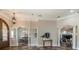 An airy living room boasting decorative columns, arched doorway and ample natural light, creating an inviting atmosphere at 6357 Ashley Dr, Lakeland, FL 33813