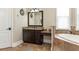 Main bathroom featuring granite countertops, tile floors, a soaking tub, and bright natural light at 6357 Ashley Dr, Lakeland, FL 33813