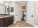 Main bathroom with tile floors, granite countertops, and bright natural light from the bedroom at 6357 Ashley Dr, Lakeland, FL 33813