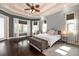 Bright main bedroom featuring hardwood floors, tray ceilings, and many large windows at 6357 Ashley Dr, Lakeland, FL 33813