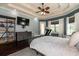 Main bedroom with a ceiling fan, ensuite, and workspace at 6357 Ashley Dr, Lakeland, FL 33813