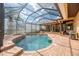 Screened in pool with jacuzzi, patio, and scenic wooded views at 6357 Ashley Dr, Lakeland, FL 33813