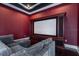 Home theater features a large screen, custom cabinetry, and comfortable gray sectional at 6357 Ashley Dr, Lakeland, FL 33813