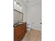 Powder room featuring a decorative wood vanity with dark countertop and gold trimmed mirror at 6542 Eagle Ridge Way, Lakeland, FL 33813