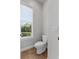 Powder room featuring a window, tile flooring and a standard toilet at 6542 Eagle Ridge Way, Lakeland, FL 33813