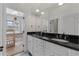 Bathroom with double sinks, dark countertops, and access to another room at 6542 Eagle Ridge Way, Lakeland, FL 33813