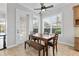 Dining room area features a wooden table and bench with chair seating next to a large window at 6542 Eagle Ridge Way, Lakeland, FL 33813