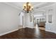 Elegant dining room with beautiful hardwood floors, trim work, and chandelier at 6542 Eagle Ridge Way, Lakeland, FL 33813