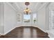 Dining room featuring hardwood flooring, a chandelier, and multiple windows providing natural light at 6542 Eagle Ridge Way, Lakeland, FL 33813