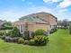 A charming home exterior with stone accents, manicured shrubs, and a lush green lawn at 6542 Eagle Ridge Way, Lakeland, FL 33813