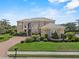 Stately two-story home with manicured lawn, stone accents, and brick driveway at 6542 Eagle Ridge Way, Lakeland, FL 33813