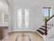 Bright foyer with tile flooring, a staircase, and decorative front doors at 6542 Eagle Ridge Way, Lakeland, FL 33813