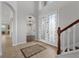 Spacious foyer with tile flooring, staircase, and a view of the dining room at 6542 Eagle Ridge Way, Lakeland, FL 33813