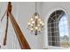 Upstairs foyer with wood railing, chandelier, and arch window at 6542 Eagle Ridge Way, Lakeland, FL 33813
