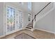 Welcoming foyer with tile floors, a staircase, and decorative front doors at 6542 Eagle Ridge Way, Lakeland, FL 33813