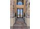 Elegant double front doors with glass detailing, flanked by potted plants at 6542 Eagle Ridge Way, Lakeland, FL 33813