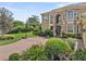 Beautifully landscaped yard with lush green grass and a brick driveway with basketball hoop at 6542 Eagle Ridge Way, Lakeland, FL 33813