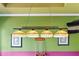 A game room featuring a vintage pool table light above a pool table and score board with a door to outside at 6542 Eagle Ridge Way, Lakeland, FL 33813