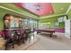 A brightly colored game room with a bar, barstools, a pool table, and a door to the outside at 6542 Eagle Ridge Way, Lakeland, FL 33813