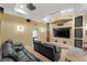 Home theater with reclining leather seating, projector screen, and movie-themed decorations at 6542 Eagle Ridge Way, Lakeland, FL 33813