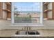 Kitchen sink with stainless steel faucet, granite countertops and window view at 6542 Eagle Ridge Way, Lakeland, FL 33813