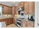 Kitchen with stainless steel stove, tan cabinets, and tile backsplash at 6542 Eagle Ridge Way, Lakeland, FL 33813