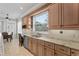 Kitchen area features tile floors, stainless steel appliances, granite countertops and window view at 6542 Eagle Ridge Way, Lakeland, FL 33813