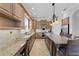 Spacious kitchen features tile flooring, large island with seating, stainless steel appliances and granite countertops at 6542 Eagle Ridge Way, Lakeland, FL 33813