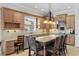 Kitchen with a large island with seating, wooden cabinets, granite countertops, and stainless steel appliances at 6542 Eagle Ridge Way, Lakeland, FL 33813