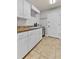Bright laundry room with white cabinets, sink, and beige countertops at 6542 Eagle Ridge Way, Lakeland, FL 33813