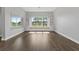 Living room with hardwood flooring, window seat, and built-in shelving at 6542 Eagle Ridge Way, Lakeland, FL 33813