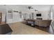 Open concept living room with tile flooring, built in shelves, and fireplace with stone accent wall at 6542 Eagle Ridge Way, Lakeland, FL 33813