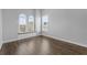 Bright room featuring natural light through large windows and a hardwood floor at 6542 Eagle Ridge Way, Lakeland, FL 33813