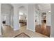 Open-concept living room with hardwood floors, a stone fireplace, and neutral decor at 6542 Eagle Ridge Way, Lakeland, FL 33813