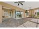 A spacious covered patio with tile flooring, ceiling fans, and a clear view of the backyard at 6542 Eagle Ridge Way, Lakeland, FL 33813
