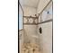 Walk-in shower featuring a built-in seat, rainfall shower head, and decorative tile accents at 6542 Eagle Ridge Way, Lakeland, FL 33813