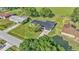 Aerial view of home with metal roof, lush landscaping, and surrounding neighborhood at 6543 Tula Ln, Lakeland, FL 33809