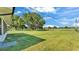 Expansive, grassy backyard with mature trees on a sunny day at 6543 Tula Ln, Lakeland, FL 33809
