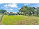 Expansive, grassy backyard with mature trees and a chain-link fence at 6543 Tula Ln, Lakeland, FL 33809