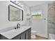 Bathroom features marble tile shower, large mirror, sleek vanity, and modern finishes at 6543 Tula Ln, Lakeland, FL 33809