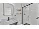 Modern bathroom featuring a black framed shower, floating shelves, and sleek fixtures at 6543 Tula Ln, Lakeland, FL 33809