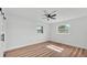 Bright bedroom with two windows providing natural light and wood-look laminate flooring at 6543 Tula Ln, Lakeland, FL 33809