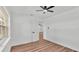 Bedroom with ceiling fan, wood floors, and an open white door at 6543 Tula Ln, Lakeland, FL 33809