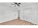 Bedroom with wood floors, a ceiling fan, and a closet with sliding doors at 6543 Tula Ln, Lakeland, FL 33809