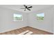 Bright bedroom with two windows providing natural light and wood-look laminate flooring at 6543 Tula Ln, Lakeland, FL 33809