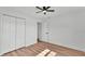 Bedroom featuring wood-look laminate flooring and a closet with folding doors at 6543 Tula Ln, Lakeland, FL 33809