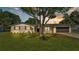 Charming single-story home featuring a well-manicured lawn, painted brick, and a sleek black roof at 6543 Tula Ln, Lakeland, FL 33809