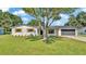 Exterior of home featuring large tree, garage and brick exterior at 6543 Tula Ln, Lakeland, FL 33809