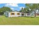 Charming single story home with black metal roof, brick facade and wood shutters at 6543 Tula Ln, Lakeland, FL 33809